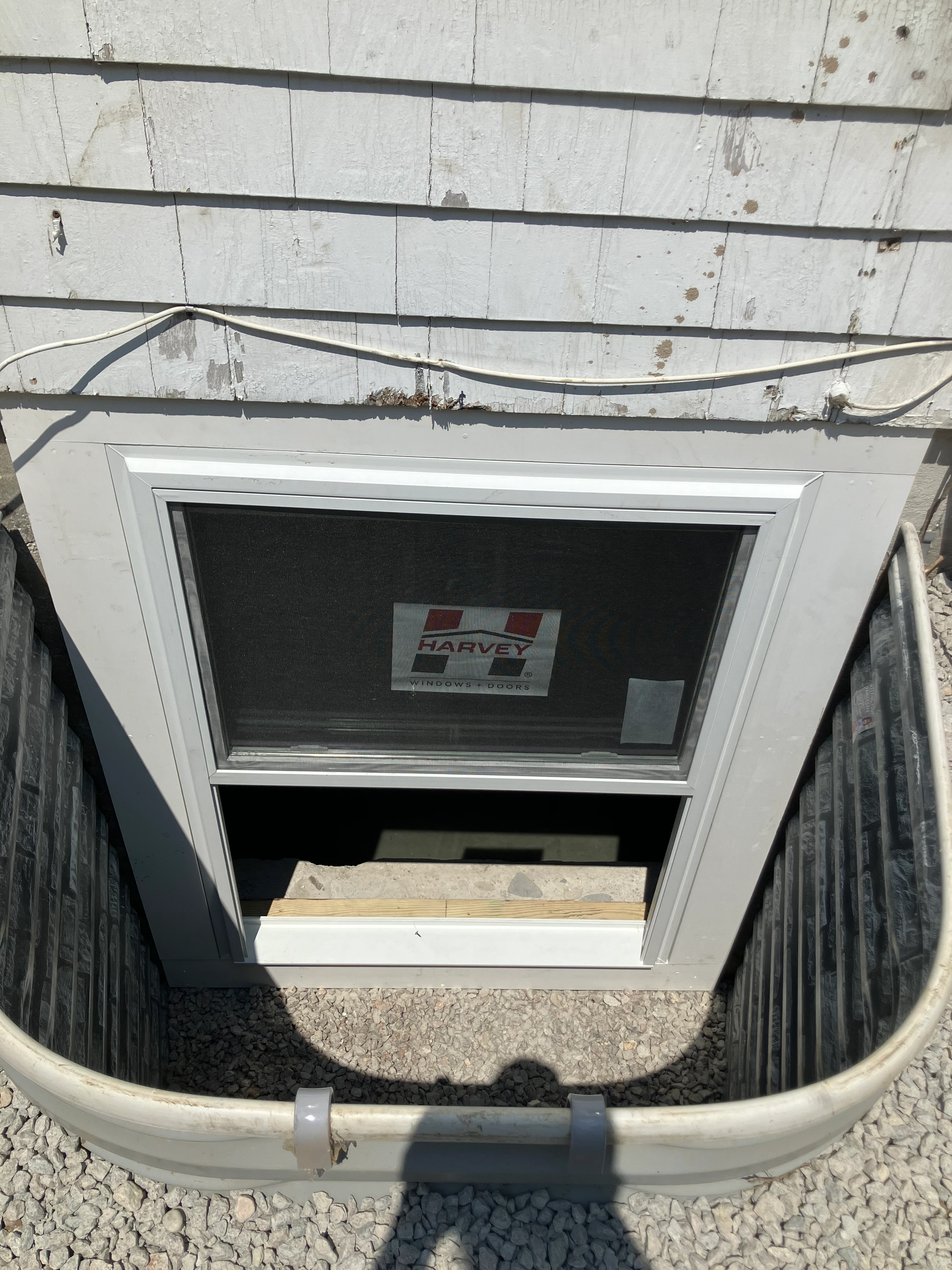 Newly installed basement egress window with window well