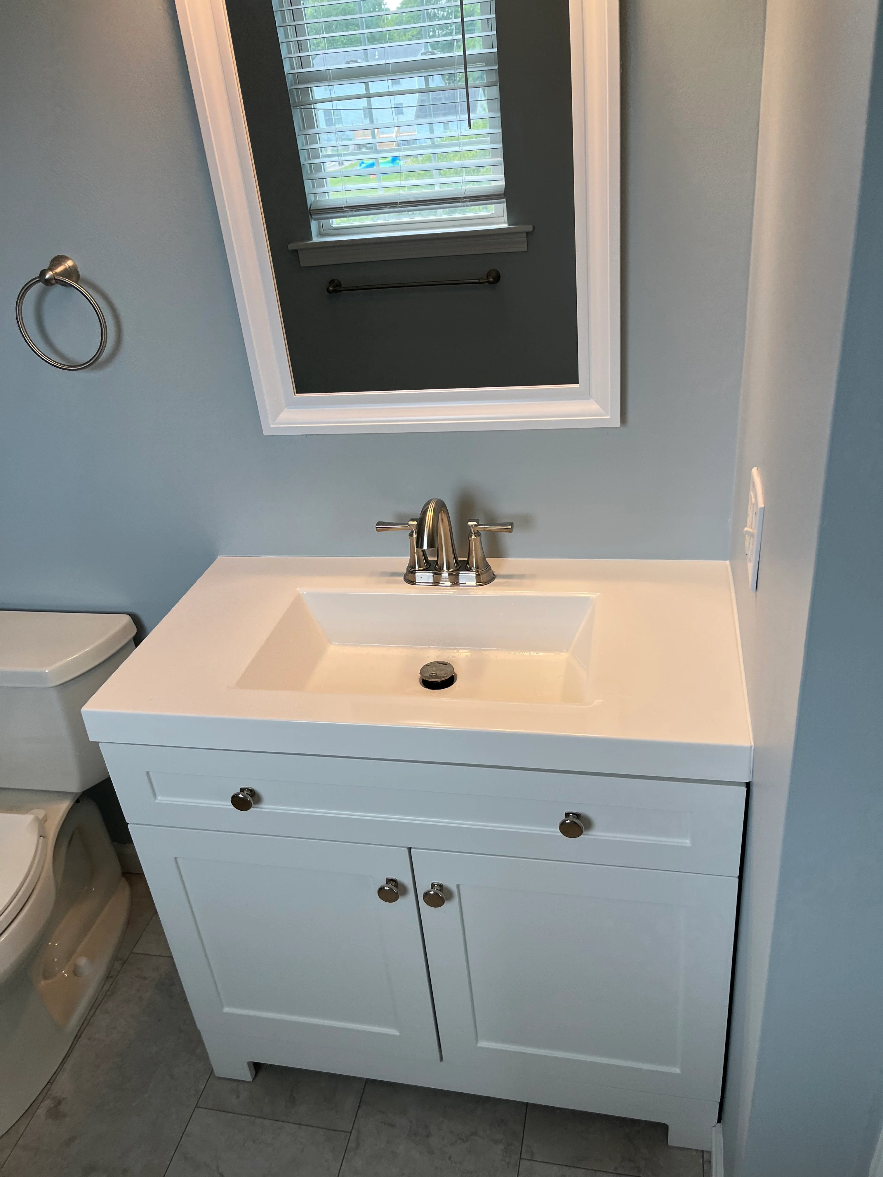 Bathroom vanity with marble countertop and brass fixtures