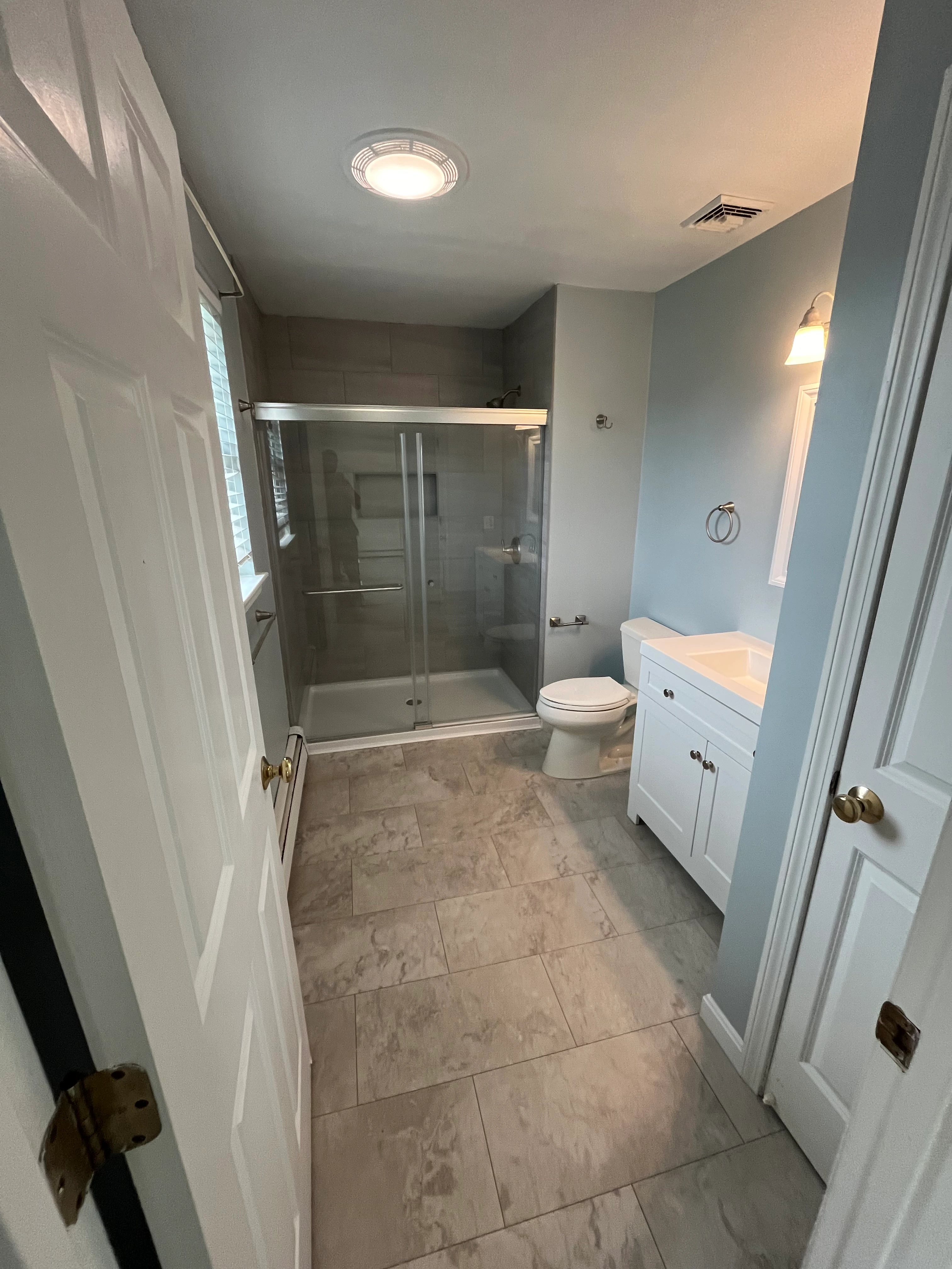 Bathroom detail showing tiled shower and vanity