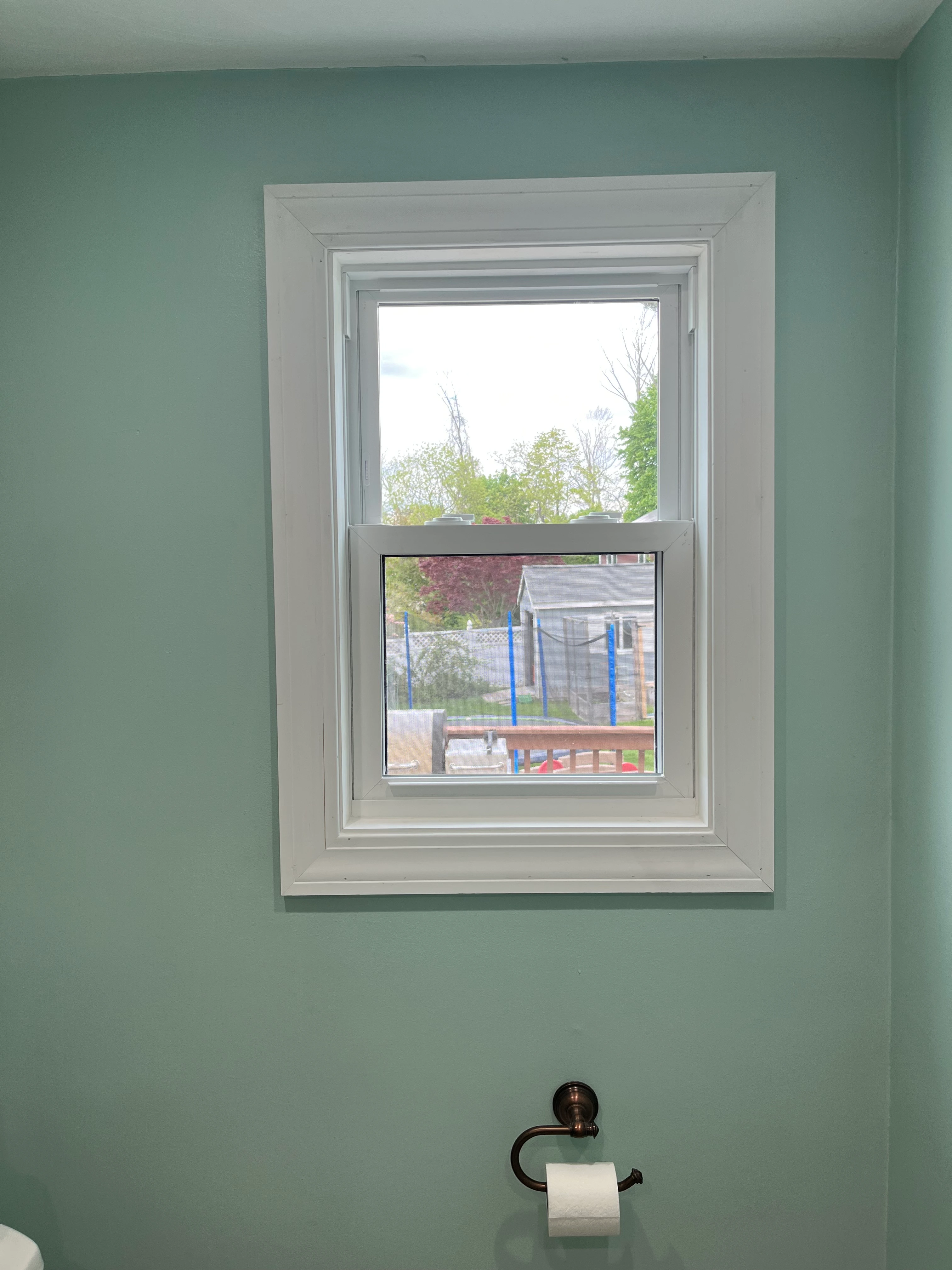 Bathroom window with trimmed casing and tile surround