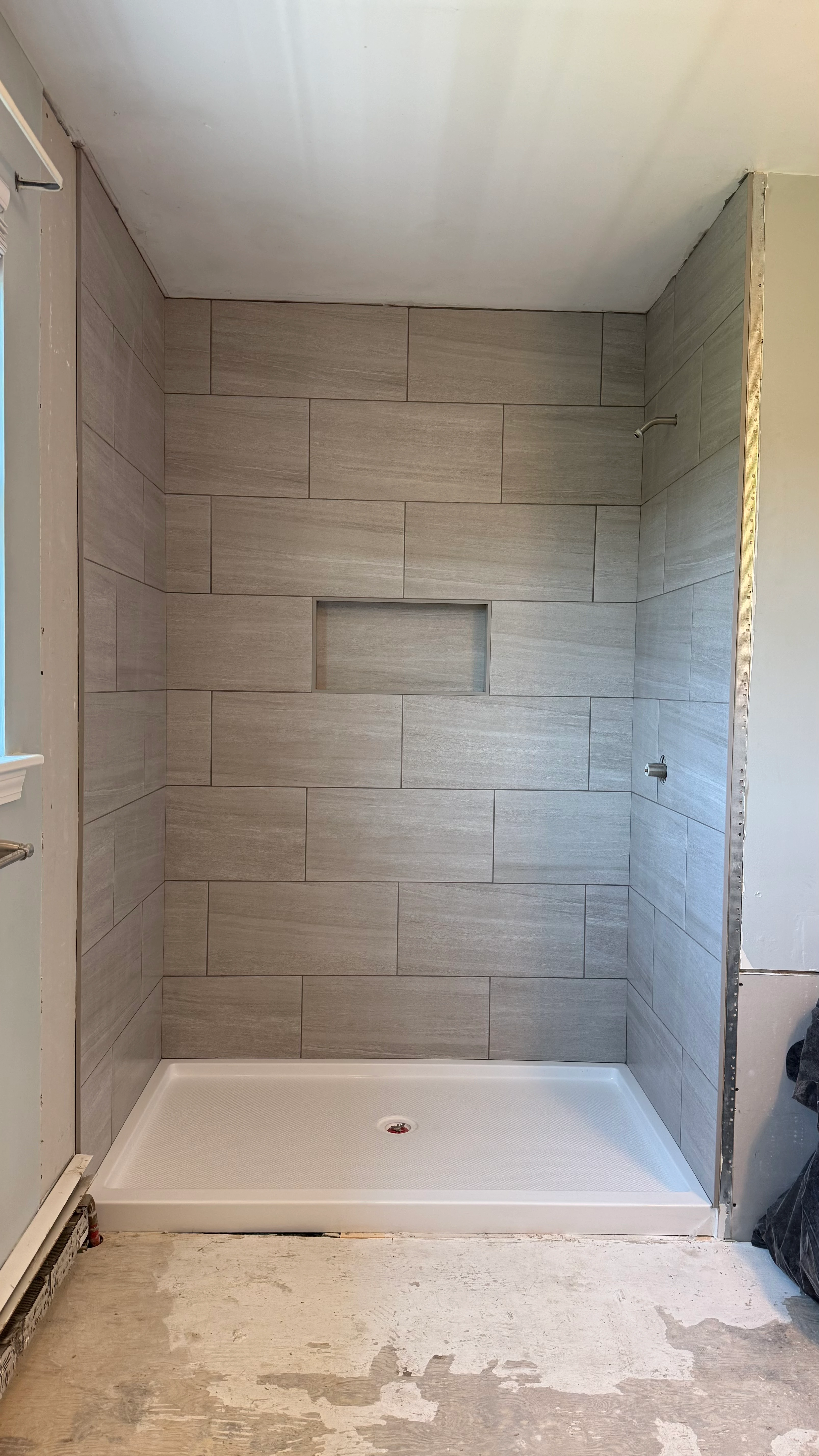 Bathroom shower tile detail with brass fixtures