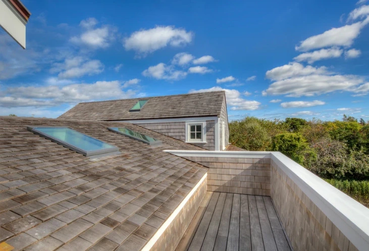 Pool pavilion with white columns, standing-seam metal roof, and ipe decking — Newport, RI