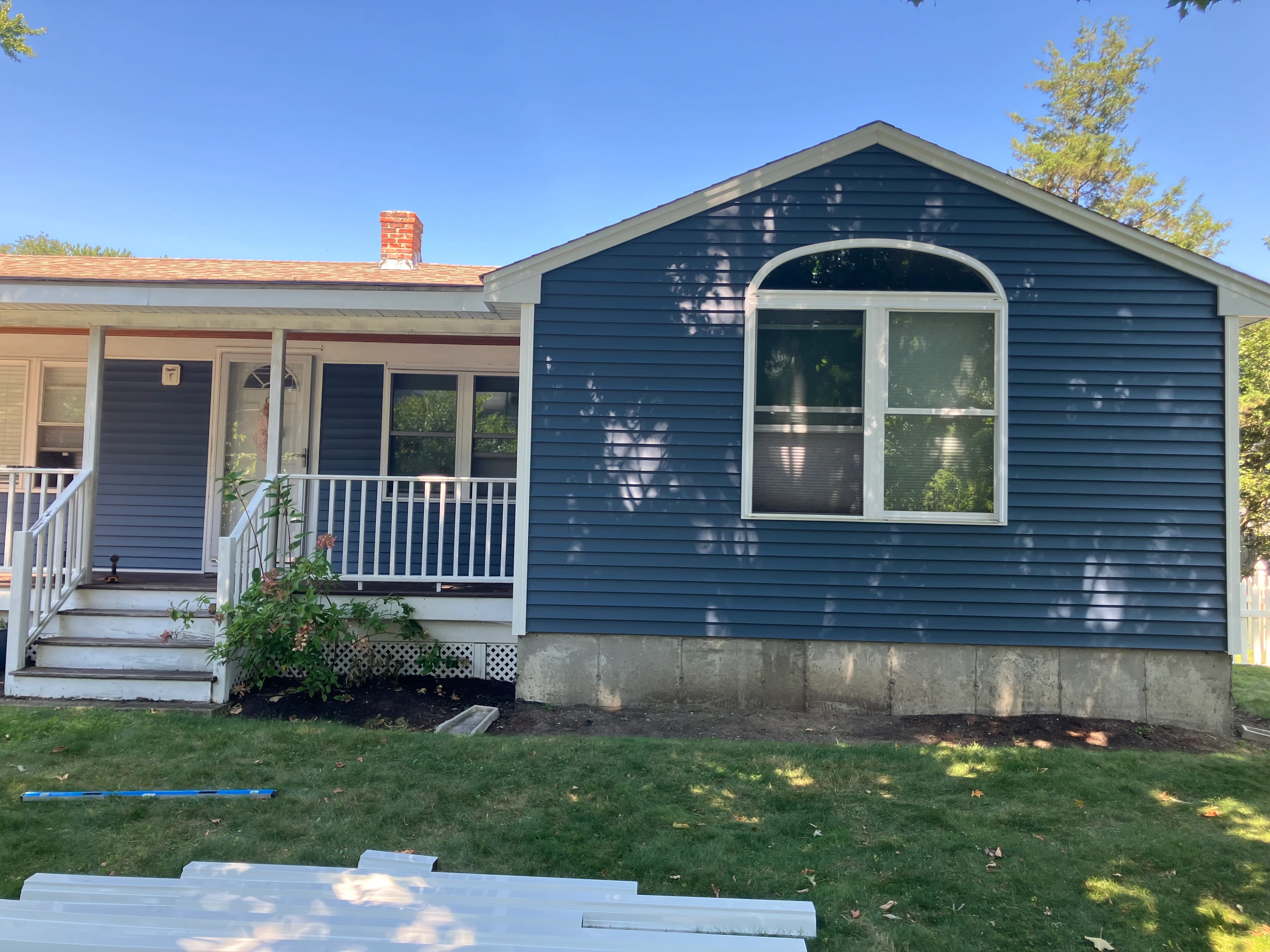 New steel-blue vinyl siding installed on the rear gable