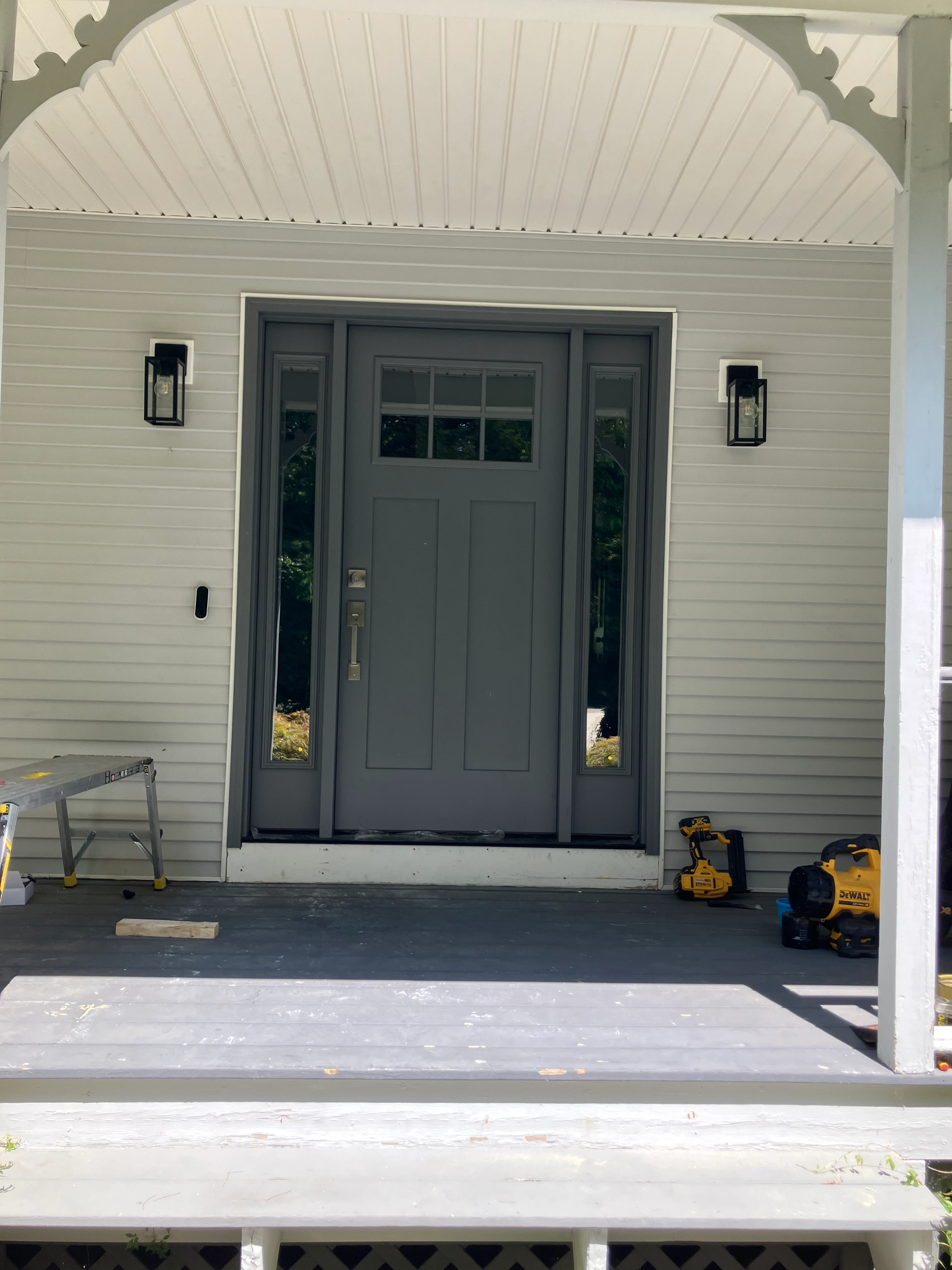 Front entry porch with restored railing viewed from the walkway