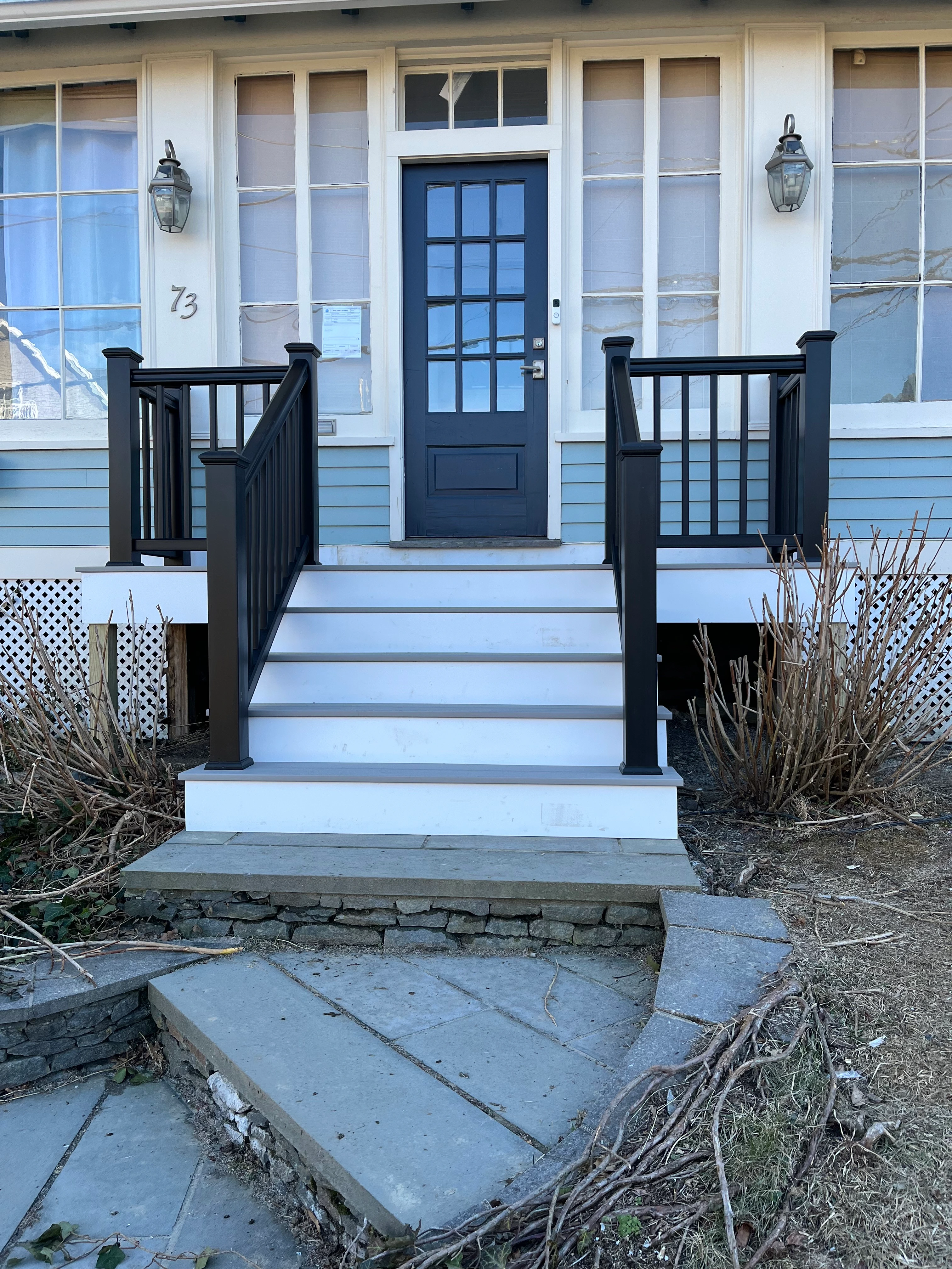 Front entry porch restoration with railing and trimmed steps