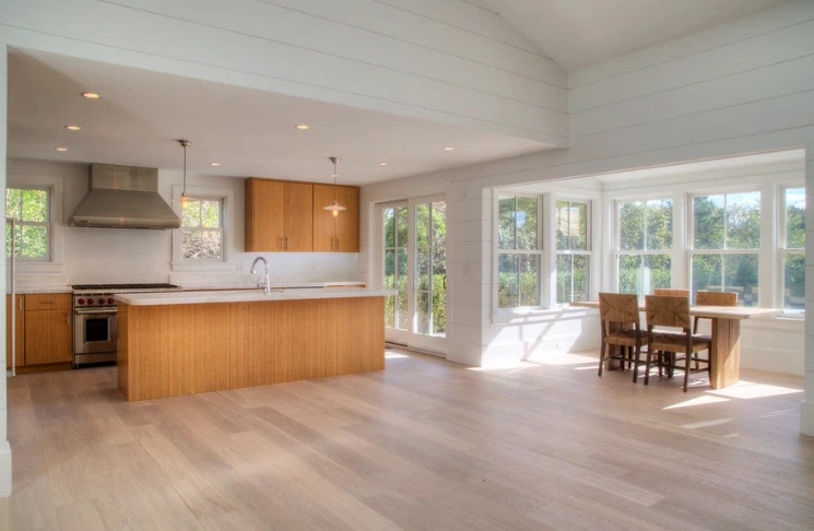 Open kitchen with maple cabinets and white oak floors