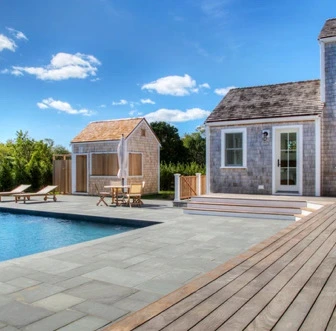 Pool pavilion and outdoor kitchen viewed from the pool deck