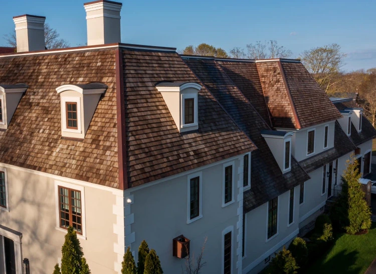Custom copper gutter installed against a natural slate roof